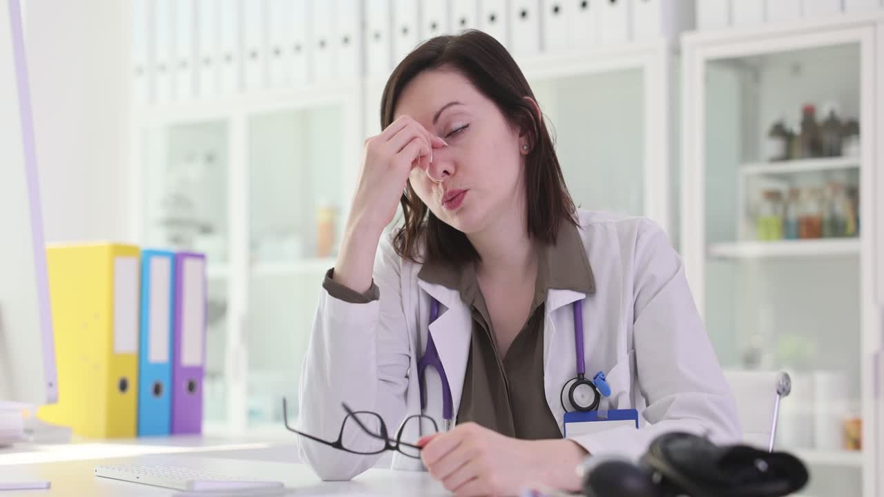 Tired doctor in her office