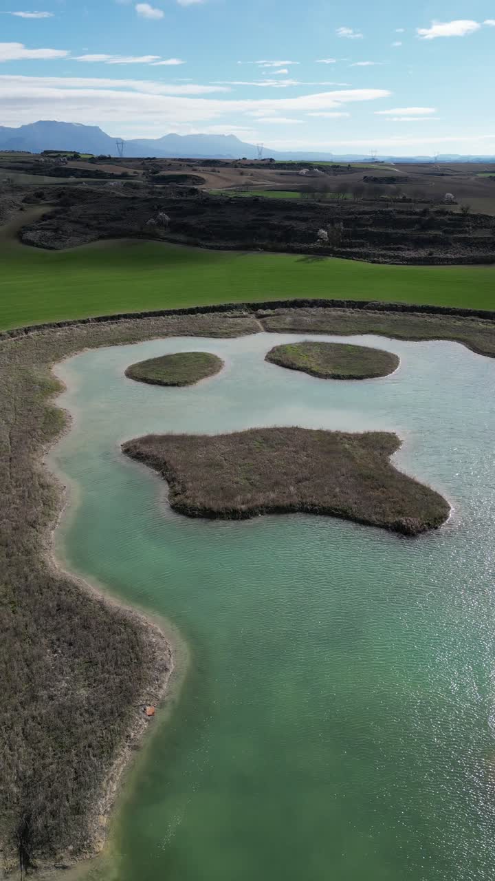 Rippling lake in mountainous countryside on sunny day in la Rioja Spain