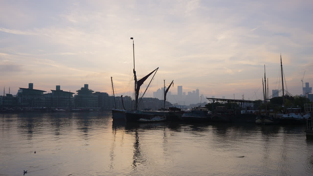 Sunrise over London's River Thames with historic boats