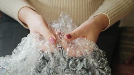 a woman pops bubble wrap 1