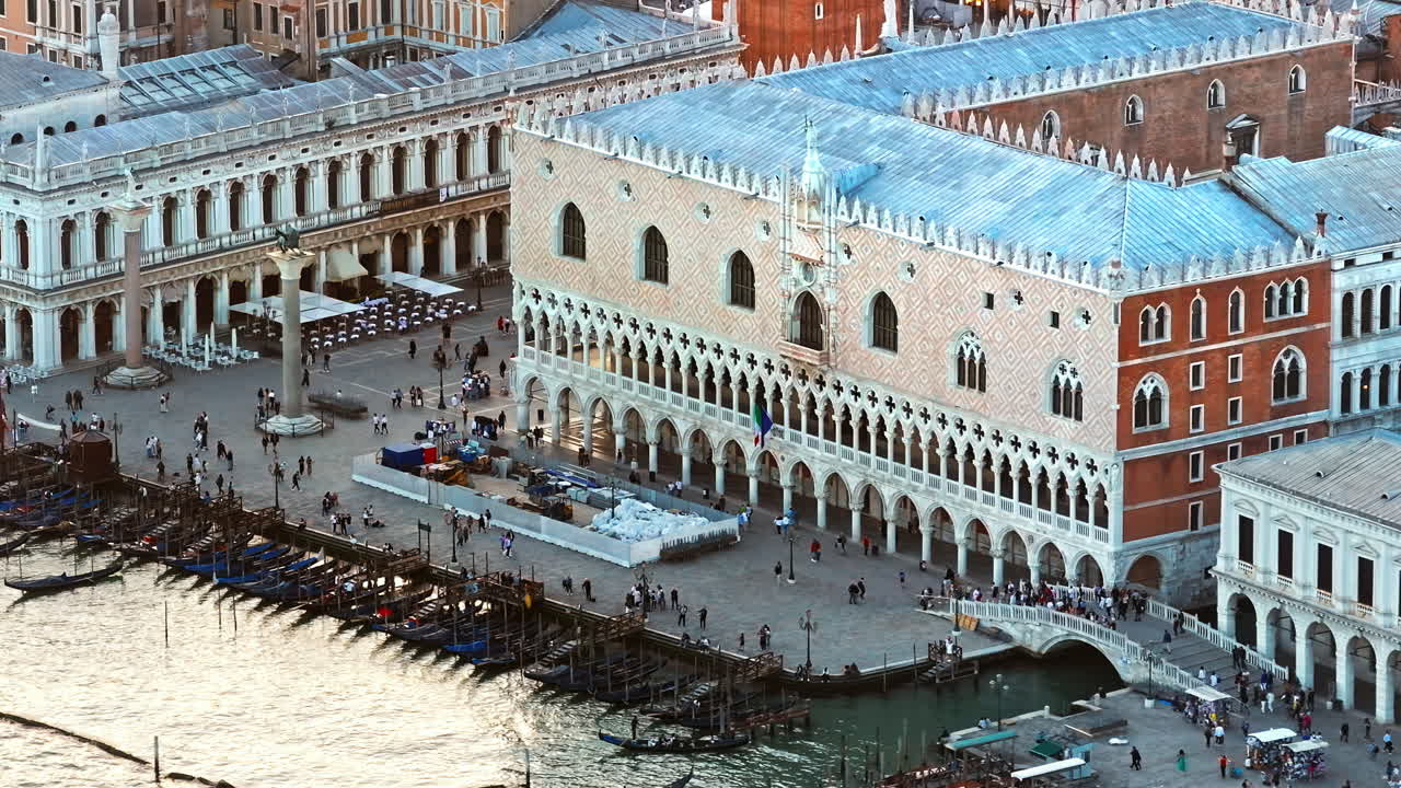 Aerial drone view of Doge's Palace in St. Mark's Square, near a harbour in Venice City, Italy on a sunny day