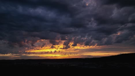 panning drone shot of a golden but mysterious sunset, storm rolling in