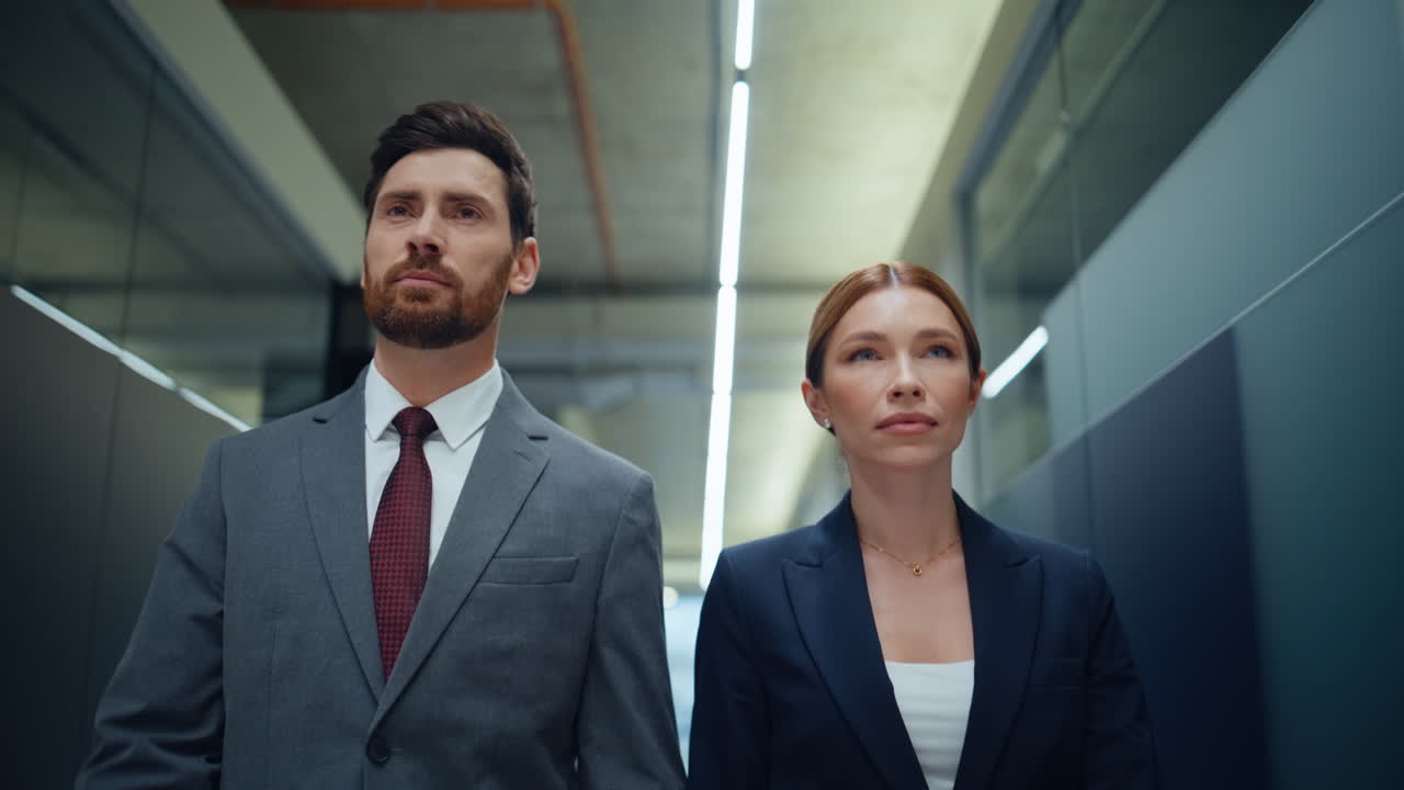 Business partners walking corporate corridor closeup. Managers looking camera
