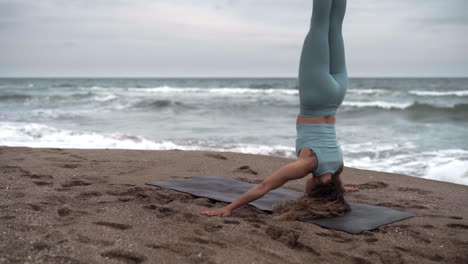 self care fitness headstand sirsasana at sant sebastia beach barcelona