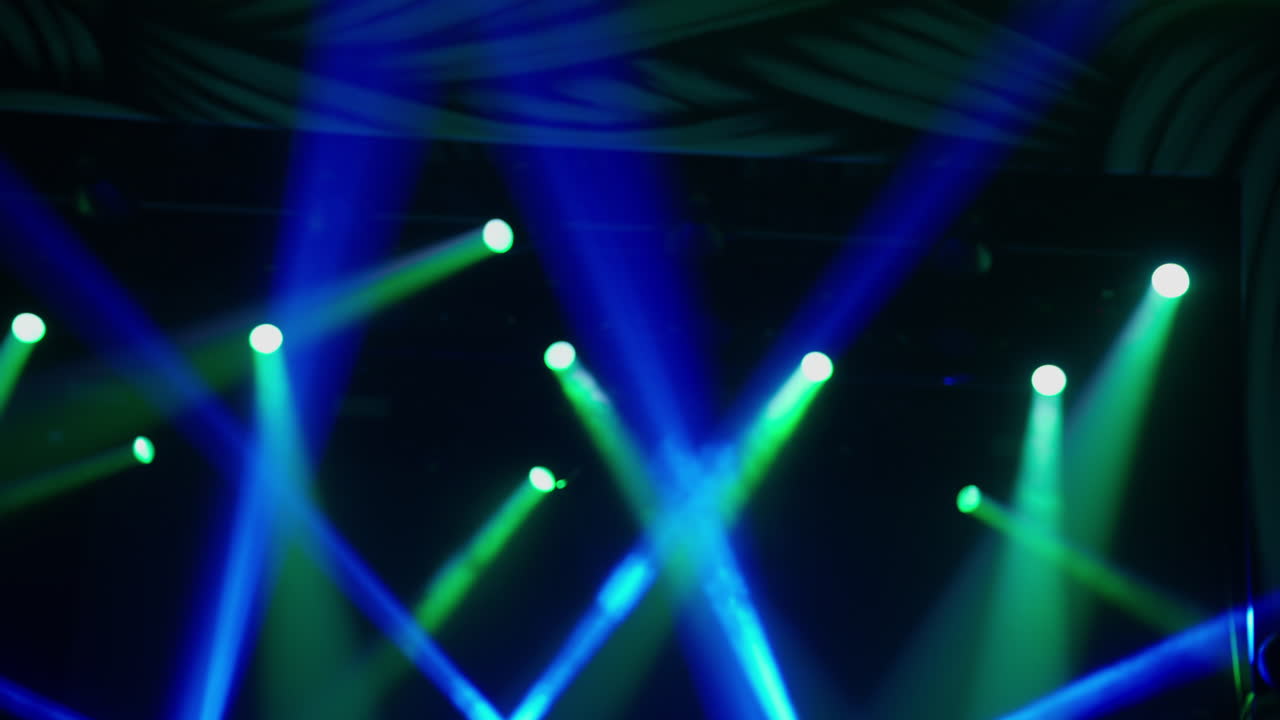 Dynamic Stage Lights with Colorful Beams Changing on a Dark Background
