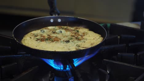 cooking an omelette on a gas stove