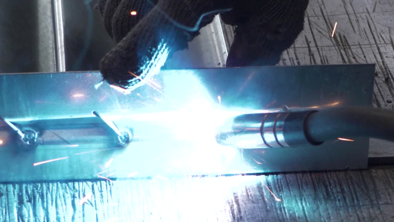 Welder works in metal construction - construction and processing of steel components