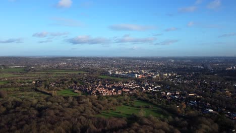 wide aerial panorama of a typical english city in summer sun and blue sky