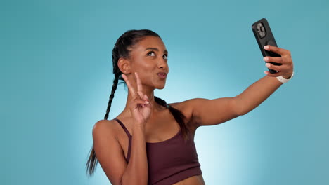 Woman,-fitness-selfie-and-studio-with-peace-sign