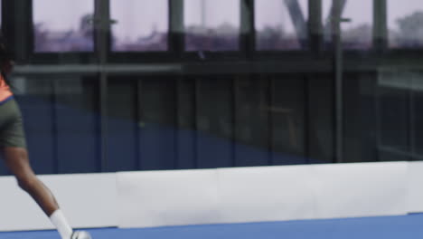 Intense padel tennis match, diverse players shaking hands showing sportsmanship, on indoor court