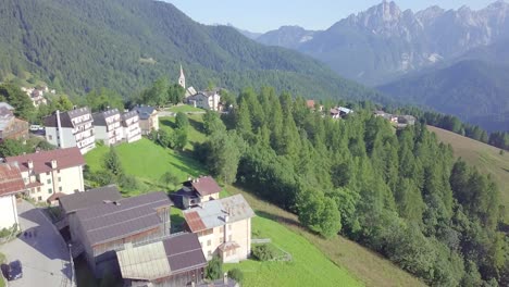 Drone-over-mountain-village-and-pine-trees