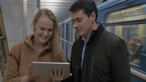 Young-people-with-tablet-computer-in-subway