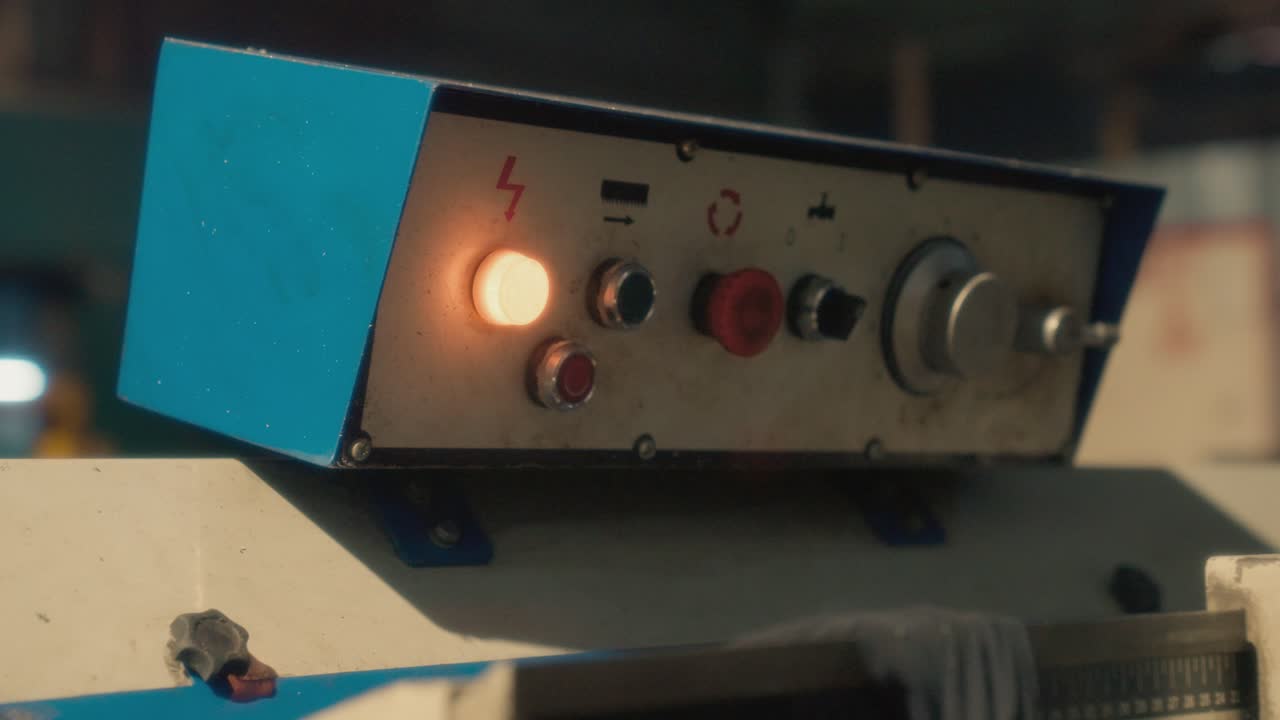 Power indicator light on cutting lathe, close up view