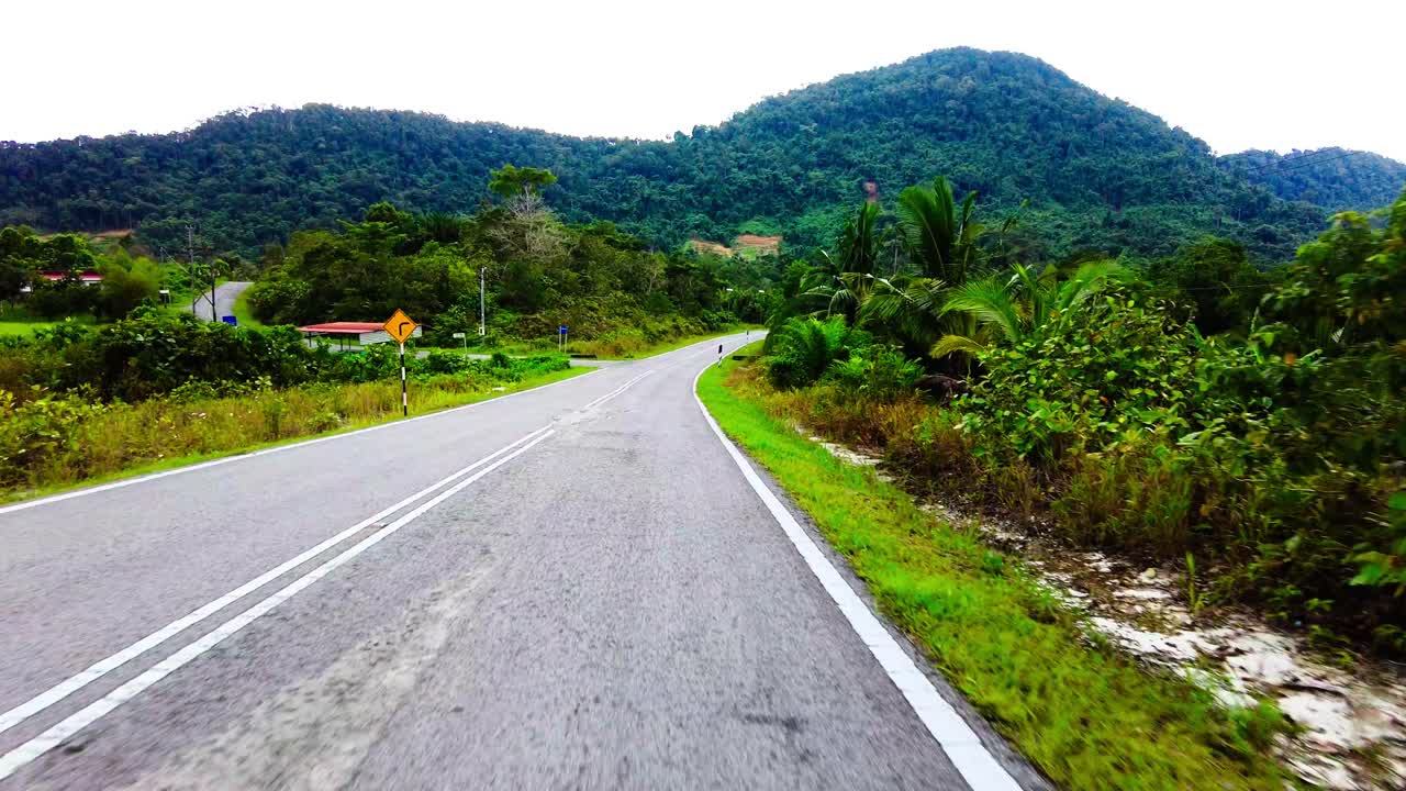 Beautiful View Drive Along Sempadi Lundu Coastal Road with Green Forest and Mountain,Sarawak,Borneo.
