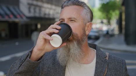 portrait-of-mature-caucasian-man-drinking-coffee-beverage-on-city-sidewalk-enjoying-happy-urban-lifestyle-real-people