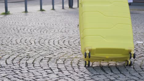 close-up, a woman with a suitcase is heading to the hotel. tourism concept