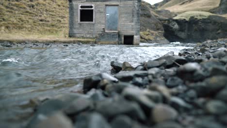 low level view of hut by a stream