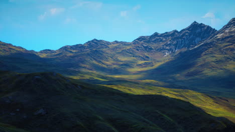 red-brown slopes and snow-capped mountain peaks