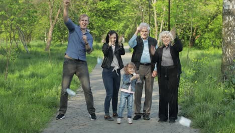 large family in park takes off medical masks after coronavirus quarantine end