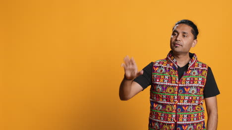 person doing calm down sign gesturing, studio background