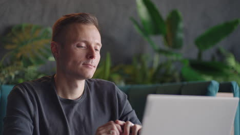 Thoughtful-serious-young-man-student-writer-sit-at-home-office-desk-with-laptop-thinking-of-inspiration-search-problem-solution-ideas-lost-in-thoughts-concept-dreaming-looking-away