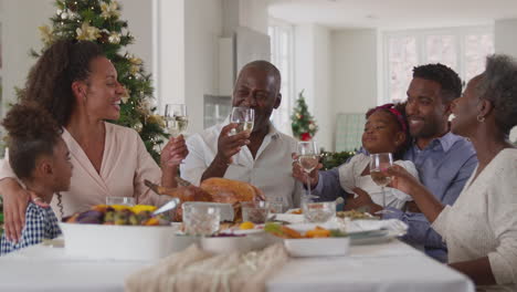 Multi-Generation-Family-Celebrating-Christmas-At-Home-Eating-Meal-Together