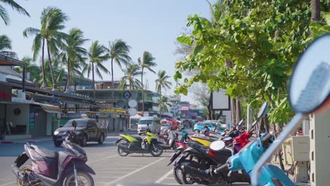 motorbikes parked roadside, tourists sunbathe sea phuket city popular beach tourism summer day .