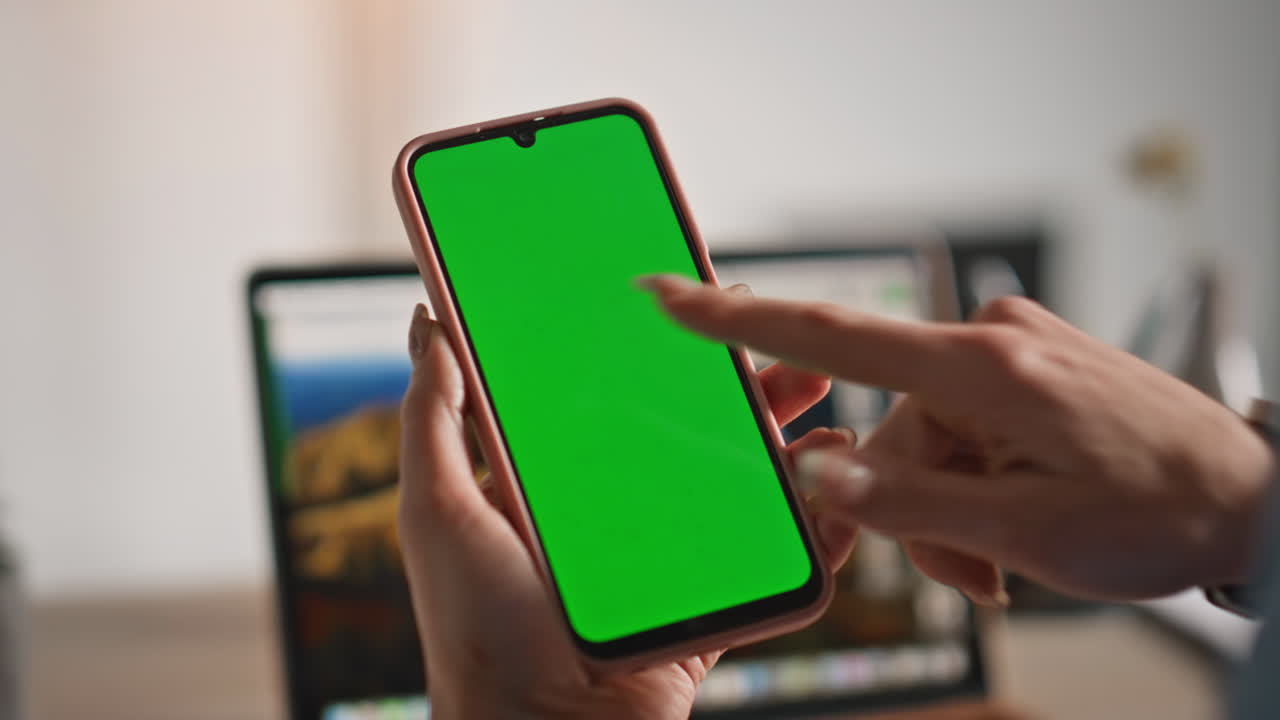 Fingers tapping mockup smartphone making online order at apartment closeup