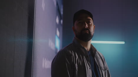 man standing in front of a led wall with neon lighting