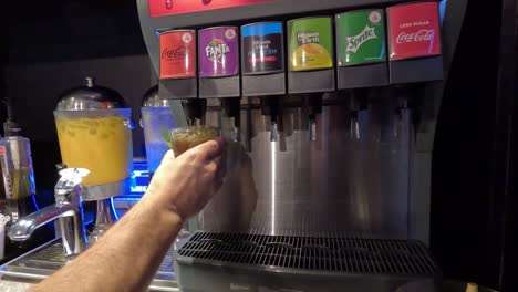 hand operating a drink dispenser lever.