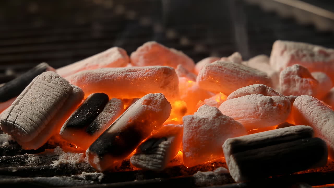 Glowing Charcoal Briquettes On Grill, Intense Orange Embers Nestled Among Ashcoated Briquettes, Thin Smoke