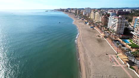 Incredible-aerial-view-of-waves-crashing-on-golden-sand-beaches-by-hotels