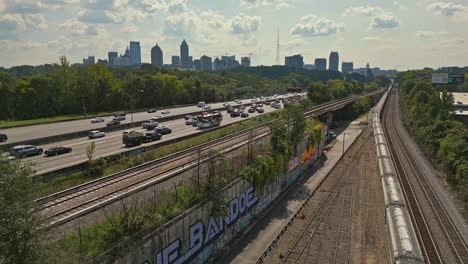 aerial view of atlanta city road traffic and passenger train with downtown atlanta skyline buildings in background, atlanta traffic, georgia, usa