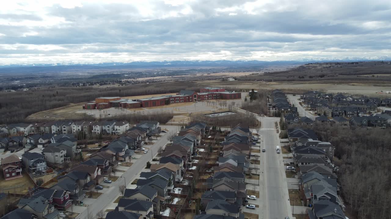 Aerial view of a modern suburban community in Calgary, Canada, in spring after the snow melt