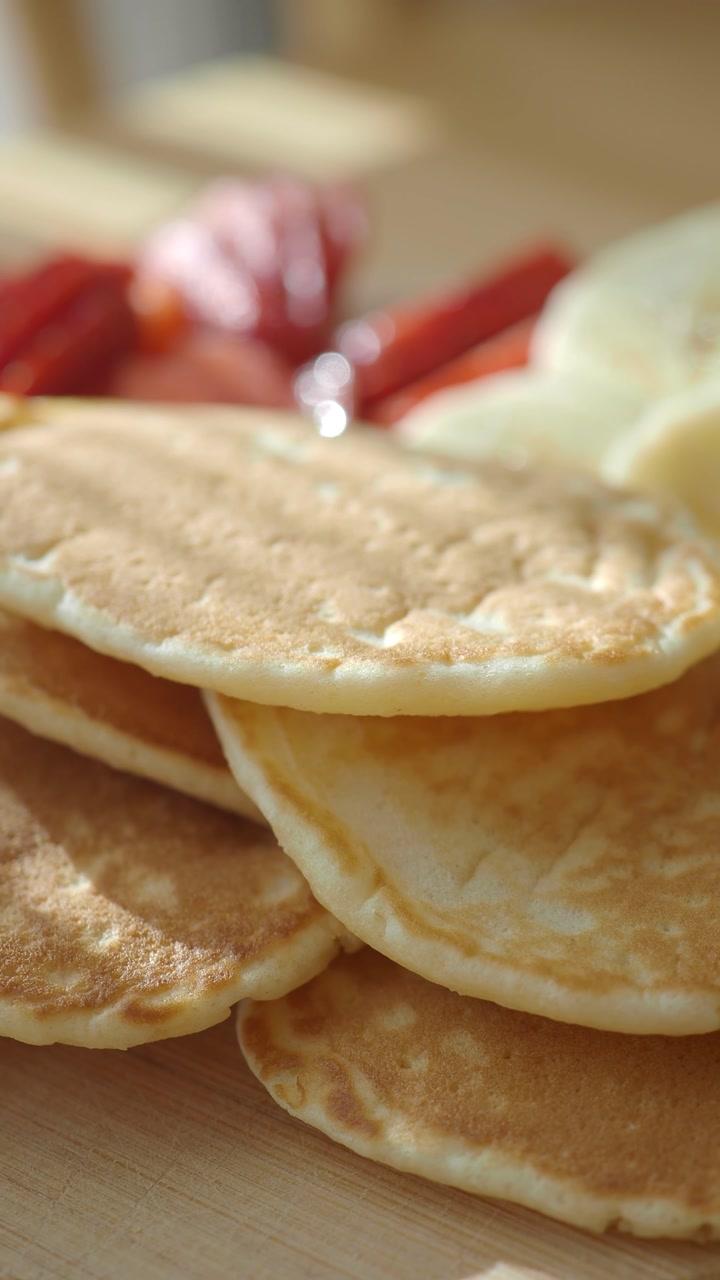 Close-up of a Stack of Golden Brown Pancakes with Fresh Fruit