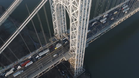 aerial view of rush hour traffic crossing new york city’s george washington bridge. shot at sunrise.