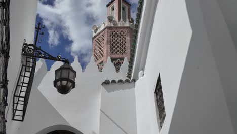 a glimpse of a traditional moroccan alleyway leading up to the kasbah mosque in tangier