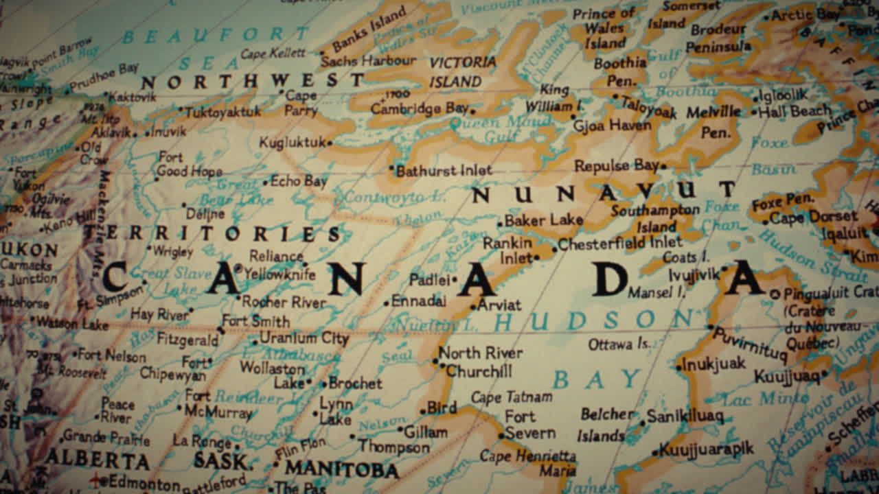 A detailed close-up view of a map of Canada, highlighting its territories, provinces, and major cities
