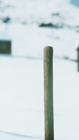 wooden post in snowy landscape