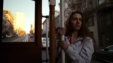 woman using a tram on a city street