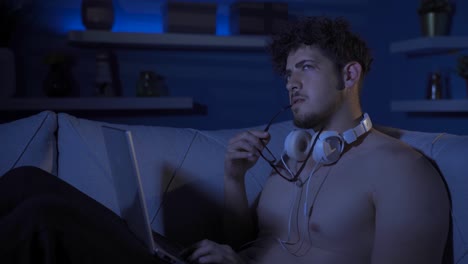 Thoughtful-young-man-using-laptop.