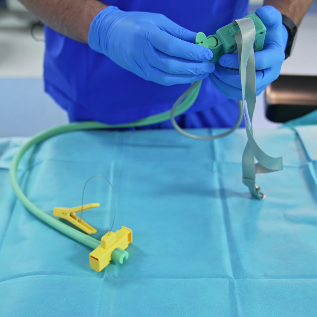 Anesthesiologist demonstrating the equipment necessary for his work. Doctor stretches the tube from a device describing its usage