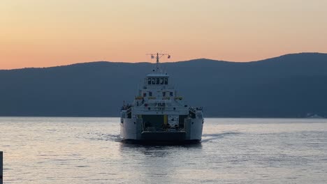 large ferryboat docked in sea at sunset