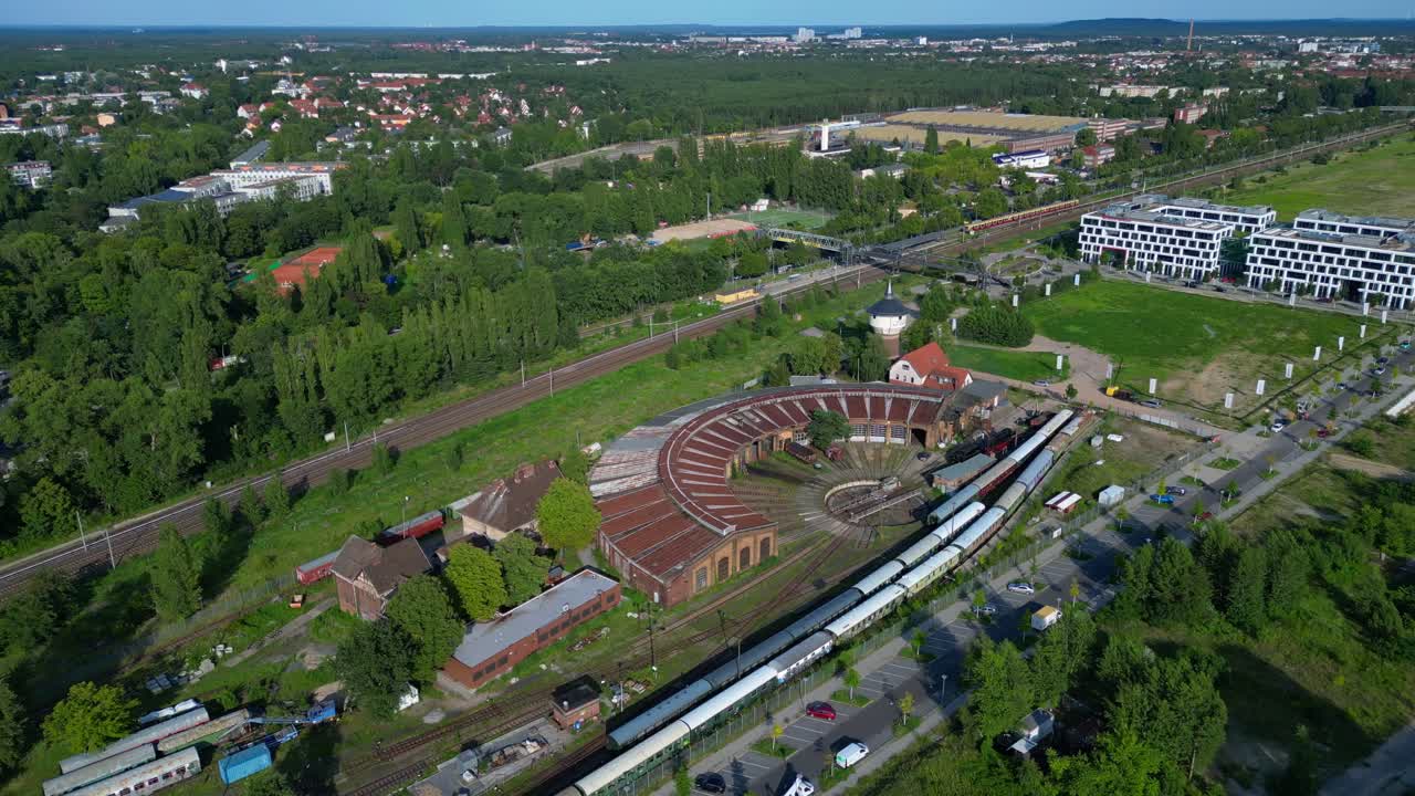 historic steam locomotive shed and trains depot with surrounding urban city Berlin Germany landscape, industrial heritage. Lovely aerial view flight drone shot from above