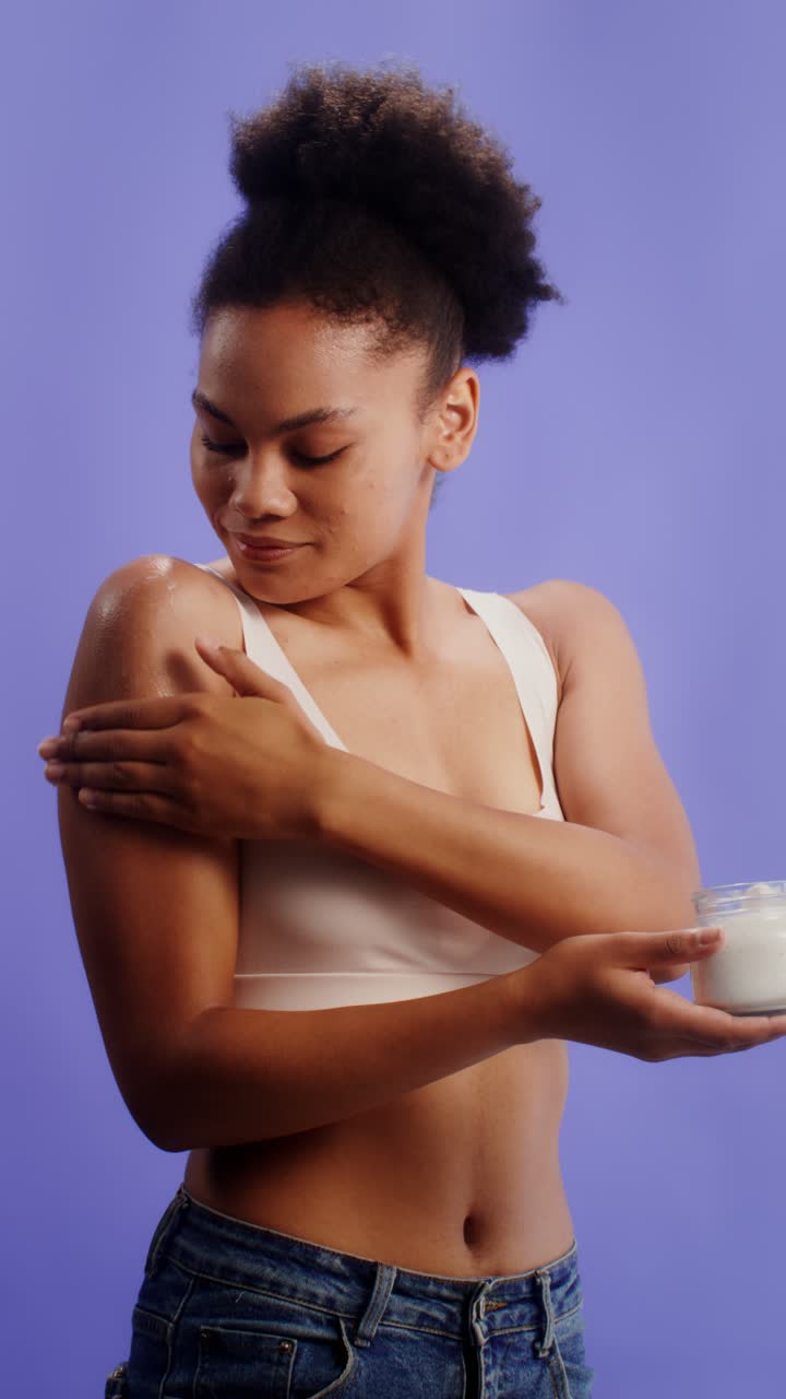 Woman applying body lotion for skincare