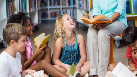 Animation-of-smiling-schoolchildren-sitting-on-floor-listening-to-teacher-reading