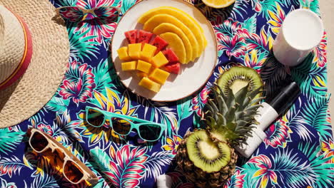 vibrant tropical picnic with fresh fruits and summer accessories