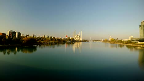 turkish flag is lowered in mourning and sabancı merkez mosque on the river in adana