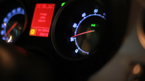 dashboard of moving car. tachometer arrow revving in moving car