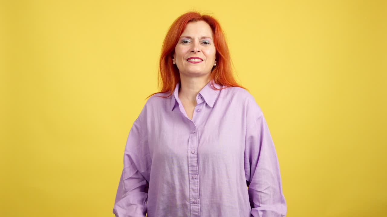 Expressive Redhead Woman on Yellow Background
